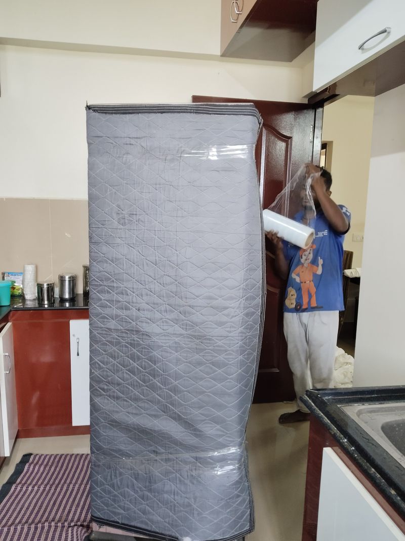 A1 Anna crew stretch-wrapping furniture on site in Coimbatore